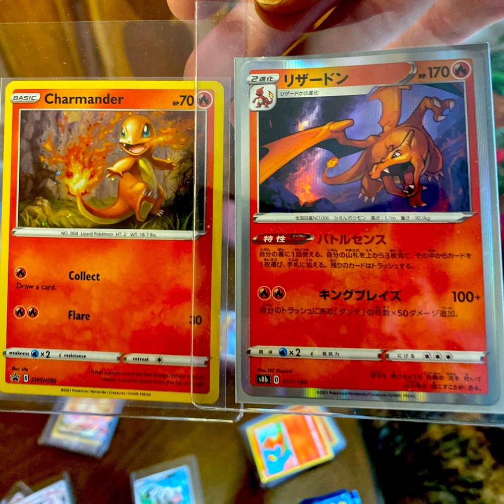 Pokémon Charizard and Chamander (one Japanese, One with Swirl)